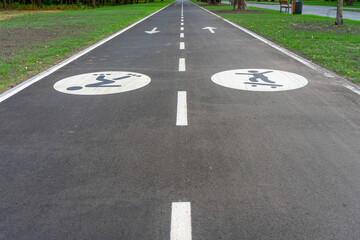 The bike path in Muromets Park in Kyiv, Ukraine, winds through scenic greenery, offering a peaceful...