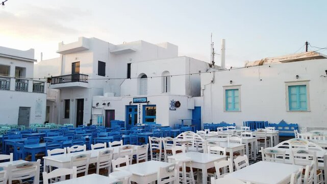 Naoussa typical waterfront view with cafe tables, small village on Paros island, Greece