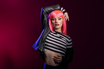 Strong elegant woman projects attitude in studio using bold expression and confident posture....