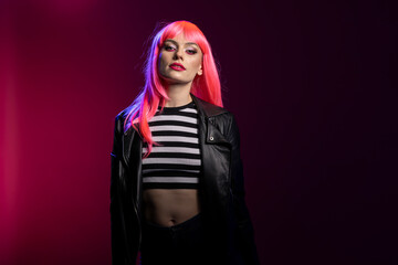 Confident female model throws bold attitude with intense eye contact and edgy styling. Pretty woman...