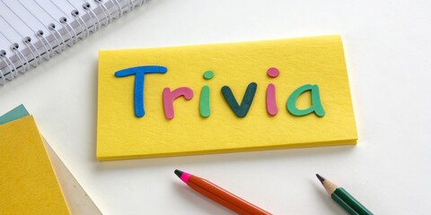Colorful Trivia Notecard Flatlay Composition with Foam Letters, Yellow Background, pencils, Game, Quiz Game, Quiz