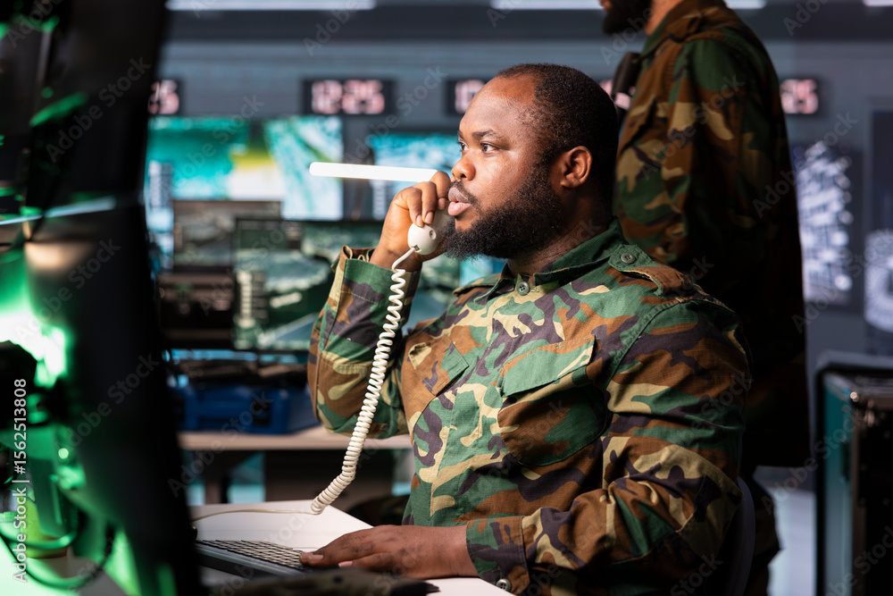 Poster intelligence officer using communication systems to call in air strikes on enemy troops. military di