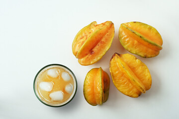 Refreshing carambola (star fruit) juice, rich in potassium, and vitamins A and C, served in a glass on a white background