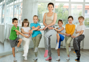 Boys and girls holding hands with woman coach and perform incendiary traditional Irish folk dance...