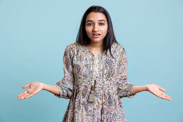 Unaware young adult saying i dont know gesture in front of the camera, acting clueless and...