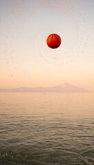 Family enjoys sunset beach fun with a vibrant ball in flight