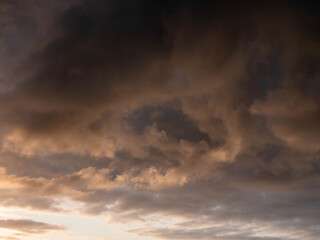 Obraz premium Dramatic sky with warm orange and dark colors of sun rise or sun set. Nature background for design.