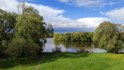 Extraordinary summer landscape. River makes bend and flows between forests and meadows. Blue sky,...