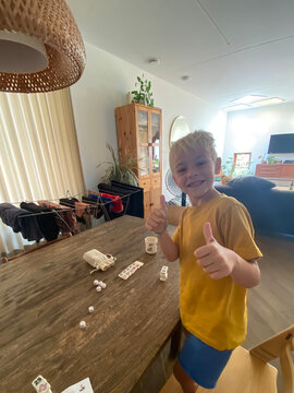 Child ready to play a board game at home
