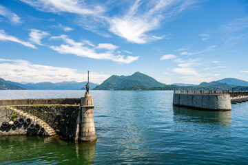 Enjoy the breathtaking view of a lake surrounded by majestic mountains and clear blue sky