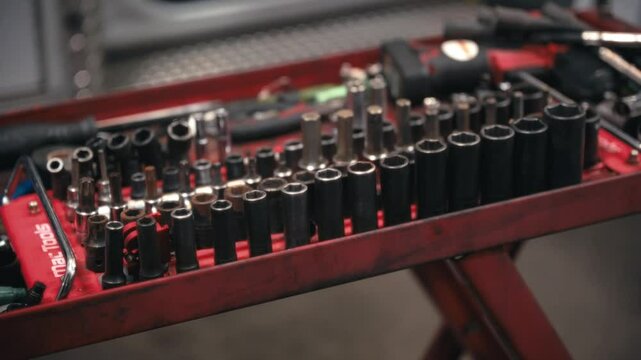 Medium close up of a kit of wrench sockets organized in a toolbox