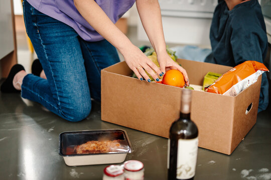 Unpacking groceries, arranging in the kitchen