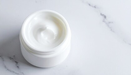 White cosmetic cream jar on marble background