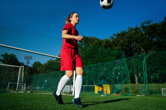 Fototapeta Female soccer player training with the ball