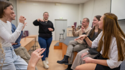 A group of young people talking in sign language. 