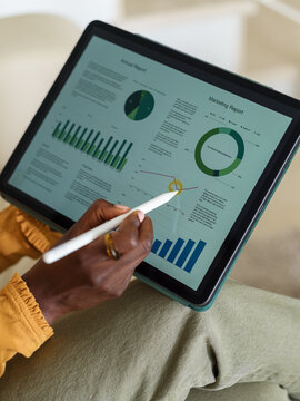 Woman analyzing information on screen of tablet computer