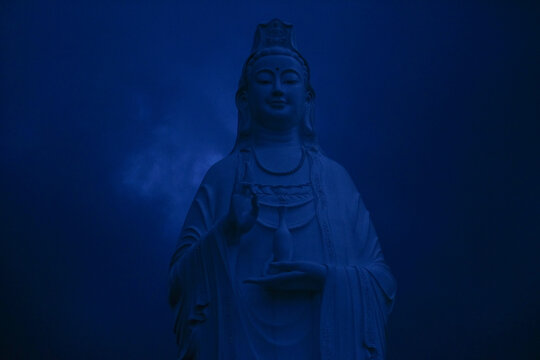 Guan Yin Statue Under a Twilight Sky