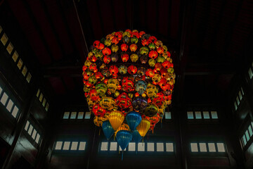 Traditional Vietnamese Lanterns in a Dark Wooden Hall