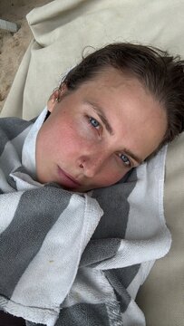 UGC Woman Relaxing on Lounger Wrapped in Towel