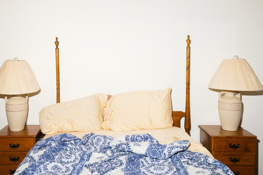 Flash photo of four poster bed and matching nightstands 