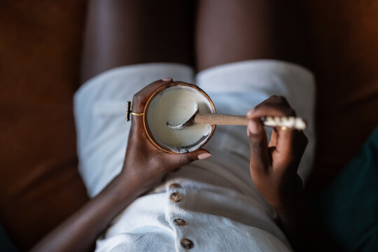 Woman eating homemade yogurt at home