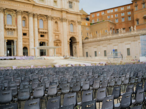 Empty chairs gathered on the square infront of  cathedral in Rome