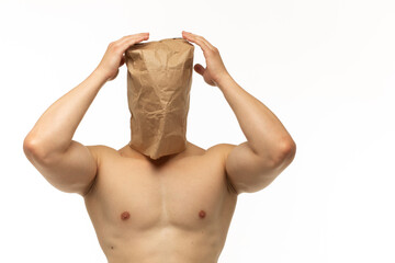 young guy with athletic and smooth body with paper bag without pictures and inscriptions on his...