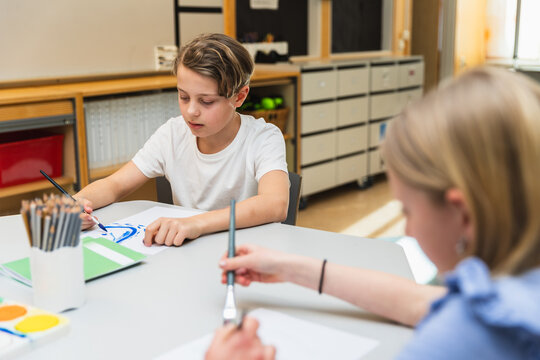 Kids Painting in Classroom