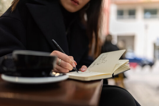 Woman drawing sketches at cafe