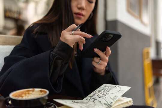 Woman using smartphone app at cafe