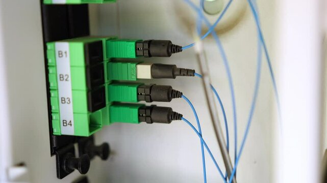 4 APC optical fiber connectors inside the DMARC, routing internet into the home