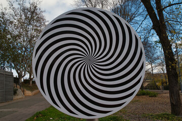 Rotating disk showing an optical illusion in the city park of Logroño, Spain.