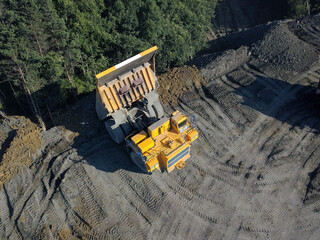 Aerial view of heavy quarry dump trucks.