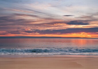 Sunset on the beach. Sandy beach with colorful surest sky. 