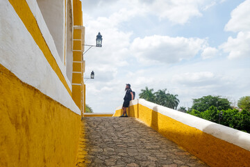 Man Walking Along Yellow Convent Wall in Izamal