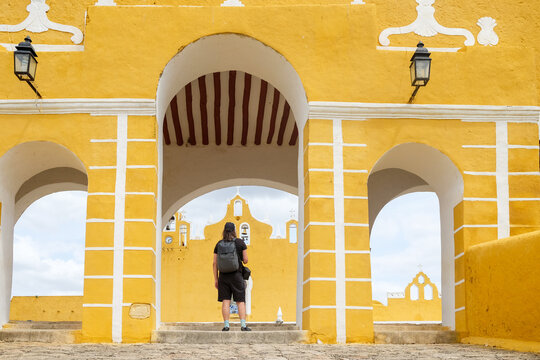  Man Standing at Arched Convent Entrance in Izamal