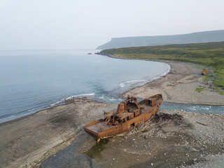 A small ship washed up on the shore.