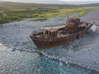 A small ship washed up on the shore.