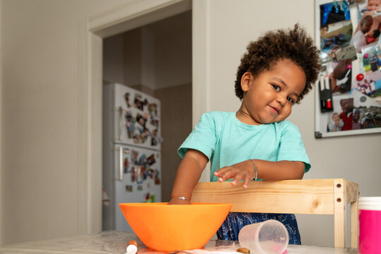 Little boy being mischievous in the kitchen