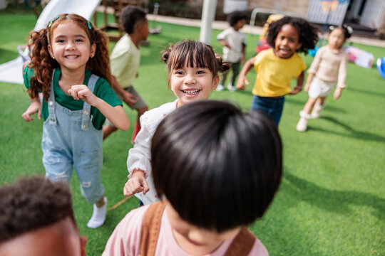 Joyful children playing on grass turf