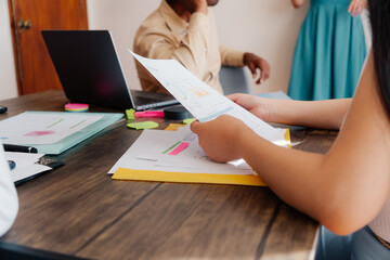 Unrecognizable person holding a document.