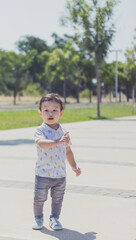 Little boy exploring a sunny park during the day, filled with joy and curiosity