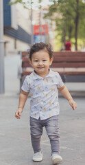 Happy toddler running joyfully in a sunny urban park, showcasing childhood innocence and exuberance