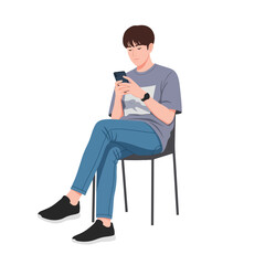 Young man casually seated, using his smartphone.