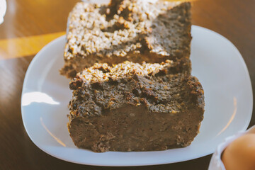 Rustic homemade bread loaf on wooden cutting board in natural sunlight, traditional artisan baking with golden crust and soft interior, comfort food concept