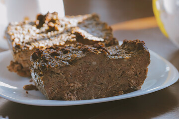 Rustic homemade bread loaf on wooden cutting board in natural sunlight, traditional artisan baking with golden crust and soft interior, comfort food concept