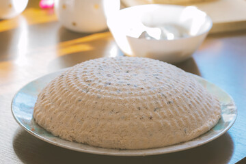 Traditional Polish Easter pascha dessert made from twaróg cheese, shaped and chilled on a plate, festive homemade sweet dish with dried fruits, holiday food photography