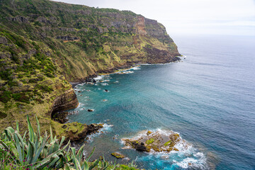 Walking path through dense vegetation towards Raposo Bay with observation of waterfall on the Azorean island of Santa Maria-Portugal © Pedro Emanuel 
