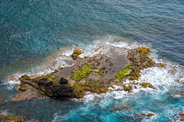 Walking path through dense vegetation towards Raposo Bay with observation of waterfall on the...