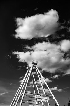 Skyward structure against a backdrop of clouds in black and white